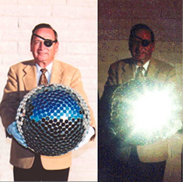 Gil Moore holding a Mock-up of the StarShine Satellite